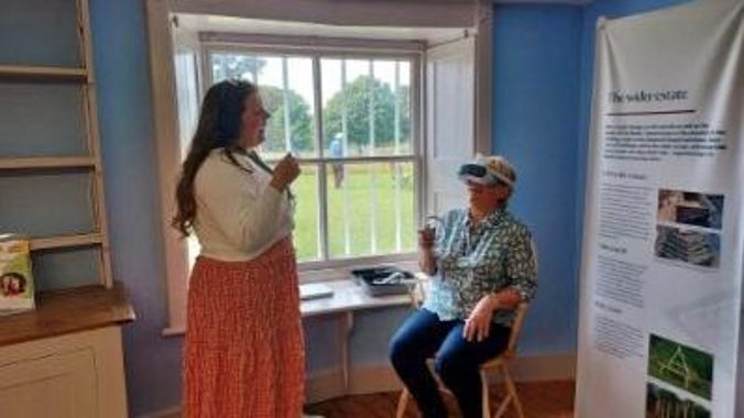 Two people test out a Virtual Reality headset showing a new virtual tour of the Shell Gallery